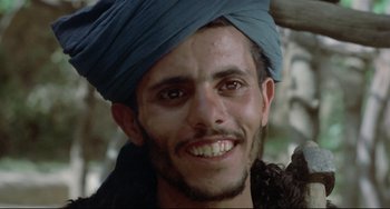 Movie still from “Arabian Nights” (1974), directed by Pier Paolo Pasolini – A person with a turban on his head; Close Up shot, Low angle