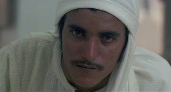 Movie still from “Arabian Nights” (1974), directed by Pier Paolo Pasolini – A person wearing a hat; Close Up shot, High angle