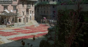 Movie still from “Arabian Nights” (1974), directed by Pier Paolo Pasolini – A group of people walking down a street with a horse drawn carriage in the background; Extreme Wide shot, High angle