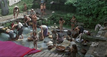 Movie still from “Arabian Nights” (1974), directed by Pier Paolo Pasolini – A group of people washing clothes in a river; Extreme Wide shot, High angle