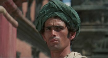 Movie still from “Arabian Nights” (1974), directed by Pier Paolo Pasolini – A person wearing a turban; Close Up shot, Low angle