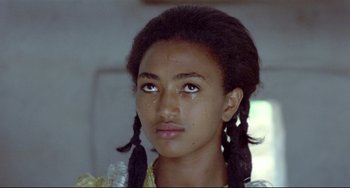 Movie still from “Arabian Nights” (1974), directed by Pier Paolo Pasolini – A young girl with braids and tears in her eyes; Close Up shot, Over the shoulder angle