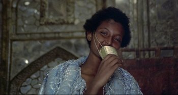 Movie still from “Arabian Nights” (1974), directed by Pier Paolo Pasolini – A woman with a mask on her face; Close Up shot, Over the shoulder angle