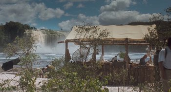 Movie still from “Arachnophobia” (1990), directed by Frank Marshall – An outdoor bar with a waterfall in the background; Extreme Wide shot, Low angle