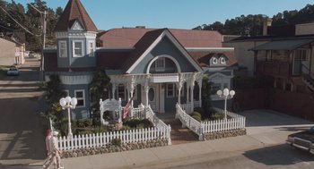 Movie still from “Arachnophobia” (1990), directed by Frank Marshall – A house that has a picket fence around it; Extreme Wide shot, High angle