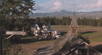 Movie still from “Arachnophobia” (1990), directed by Frank Marshall – An aerial view of an old farm house with a truck parked in front of it; Extreme Wide shot, High angle