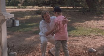 Movie still from “Arachnophobia” (1990), directed by Frank Marshall – A man and a boy playing baseball in a field; Medium shot, Low angle