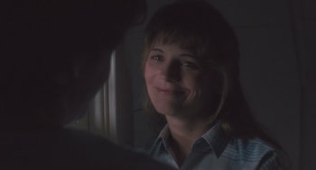 Movie still from “Arachnophobia” (1990), directed by Frank Marshall – A person smiling at the camera; Close Up shot, Over the shoulder angle