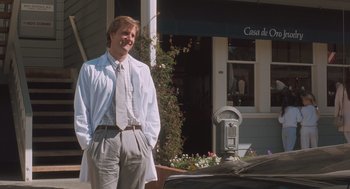 Movie still from “Arachnophobia” (1990), directed by Frank Marshall – A man standing next to a parking meter; Medium shot, Low angle