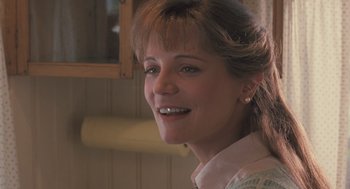 Movie still from “Arachnophobia” (1990), directed by Frank Marshall – A person smiling at the camera; Close Up shot, Low angle