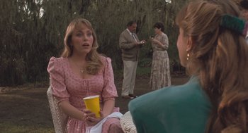 Movie still from “Arachnophobia” (1990), directed by Frank Marshall – A group of people gathered around a table; Medium shot, Over the shoulder angle