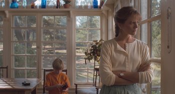 Movie still from “Arachnophobia” (1990), directed by Frank Marshall – A woman and a child in a room with windows; Medium shot, Low angle