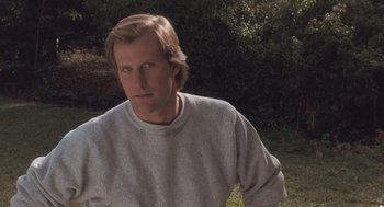Movie still from “Arachnophobia” (1990), directed by Frank Marshall – A person wearing a sweater near some trees; Close Up shot, Low angle