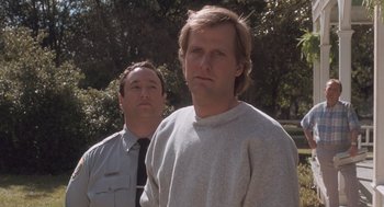 Movie still from “Arachnophobia” (1990), directed by Frank Marshall – Two men standing next to each other near a tree; Close Up shot, Low angle