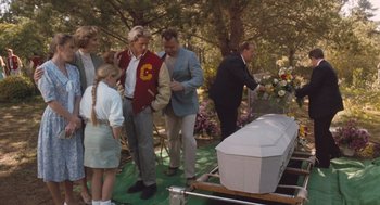 Movie still from “Arachnophobia” (1990), directed by Frank Marshall – A group of people standing around a casket; Wide shot, Over the shoulder angle