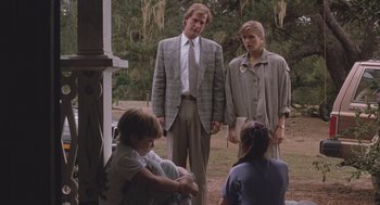 Movie still from “Arachnophobia” (1990), directed by Frank Marshall – A man and a woman standing next to a young boy; Medium shot, Low angle