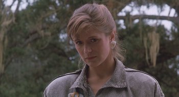 Movie still from “Arachnophobia” (1990), directed by Frank Marshall – A young woman with long blonde hair wearing a gray jacket; Close Up shot, Low angle