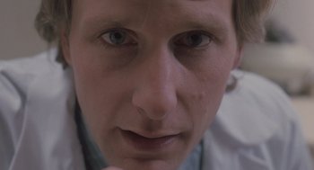 Movie still from “Arachnophobia” (1990), directed by Frank Marshall – A man's face with a white shirt; Extreme Close Up shot, Low angle