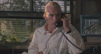 Movie still from “Arachnophobia” (1990), directed by Frank Marshall – A man talking on a phone while wearing a white shirt; Close Up shot, Low angle