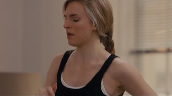 Movie still from “Arbitrage” (2012), directed by Nicholas Jarecki – A woman with a ponytail in a black tank top; Close Up shot, Over the shoulder angle
