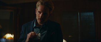 Movie still from “Archenemy” (2020), directed by Adam Egypt Mortimer – A man in a suit and tie holding a cell phone; Close Up shot, Over the shoulder angle