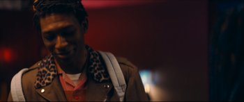 Movie still from “Archenemy” (2020), directed by Adam Egypt Mortimer – A person wearing a jacket; Close Up shot, Over the shoulder angle