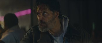 Movie still from “Archenemy” (2020), directed by Adam Egypt Mortimer – A person with a beard; Close Up shot, Low angle