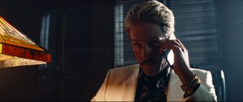 Movie still from “Archenemy” (2020), directed by Adam Egypt Mortimer – A person talking on a cell phone; Close Up shot, Low angle