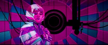 Movie still from “Archenemy” (2020), directed by Adam Egypt Mortimer – A woman standing in front of a purple wall; Medium shot, Low angle