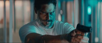 Movie still from “Archenemy” (2020), directed by Adam Egypt Mortimer – A man with a beard is looking at the camera; Close Up shot, Over the shoulder angle