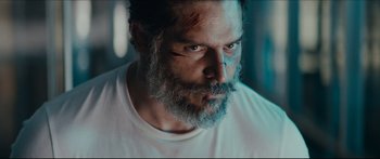 Movie still from “Archenemy” (2020), directed by Adam Egypt Mortimer – A person with a beard; Close Up shot, Low angle