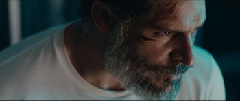 Movie still from “Archenemy” (2020), directed by Adam Egypt Mortimer – A person with a beard; Close Up shot, Low angle