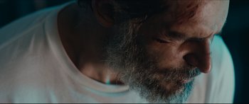 Movie still from “Archenemy” (2020), directed by Adam Egypt Mortimer – A person with a beard; Extreme Close Up shot, Low angle