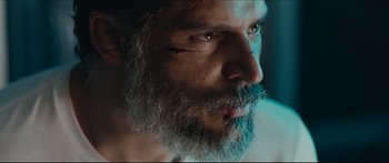 Movie still from “Archenemy” (2020), directed by Adam Egypt Mortimer – A person with a beard; Close Up shot, Low angle