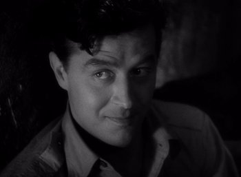 Movie still from “Arise, My Love” (1940), directed by Mitchell Leisen – Black and white photograph of a man in a shirt; Close Up shot, High angle