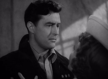 Movie still from “Arise, My Love” (1940), directed by Mitchell Leisen – A man in a black jacket is talking to a woman in a black jacket; Close Up shot, Over the shoulder angle