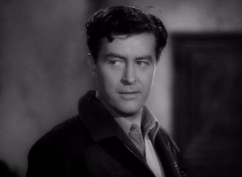 Movie still from “Arise, My Love” (1940), directed by Mitchell Leisen – A man in a black and white photo looking at the camera; Close Up shot, Low angle