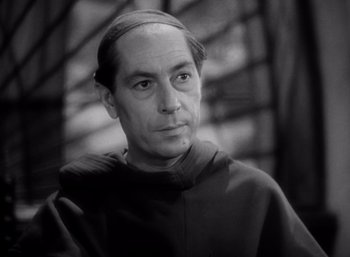 Movie still from “Arise, My Love” (1940), directed by Mitchell Leisen – Black and white photograph of a man wearing a monk's robe; Close Up shot, High angle