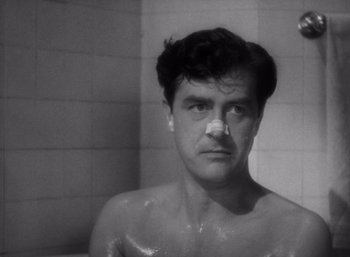 Movie still from “Arise, My Love” (1940), directed by Mitchell Leisen – A black - and - white photo of a man taking a shower; Close Up shot, High angle