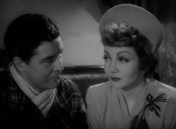 Movie still from “Arise, My Love” (1940), directed by Mitchell Leisen – A man and a woman sitting next to each other; Close Up shot, High angle