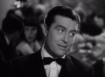 Movie still from “Arise, My Love” (1940), directed by Mitchell Leisen – A black and white photo of a man in a tuxedo; Close Up shot, Over the shoulder angle