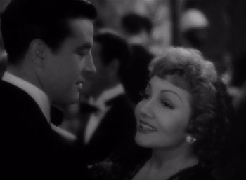 Movie still from “Arise, My Love” (1940), directed by Mitchell Leisen – A man and a woman are smiling at each other; Close Up shot, High angle