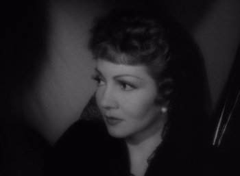 Movie still from “Arise, My Love” (1940), directed by Mitchell Leisen – An old photo of a woman in a black dress; Close Up shot, High angle
