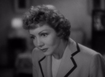 Movie still from “Arise, My Love” (1940), directed by Mitchell Leisen – An old photo of an older woman in a suit; Close Up shot, High angle