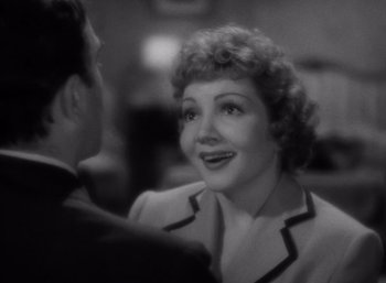 Movie still from “Arise, My Love” (1940), directed by Mitchell Leisen – An older woman talking to a man in a black and white photo; Close Up shot, Over the shoulder angle