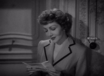 Movie still from “Arise, My Love” (1940), directed by Mitchell Leisen – An old photo of a woman looking at a piece of paper; Close Up shot, High angle