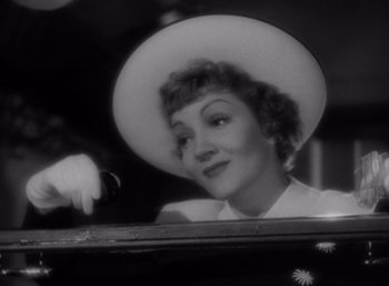 Movie still from “Arise, My Love” (1940), directed by Mitchell Leisen – An old black and white photo of a woman with a hat; Close Up shot, Low angle