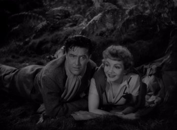 Movie still from “Arise, My Love” (1940), directed by Mitchell Leisen – A man and a woman laying on the ground; Medium shot, High angle