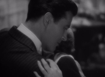 Movie still from “Arise, My Love” (1940), directed by Mitchell Leisen – A black and white photo of a man and a woman hugging; Close Up shot, High angle
