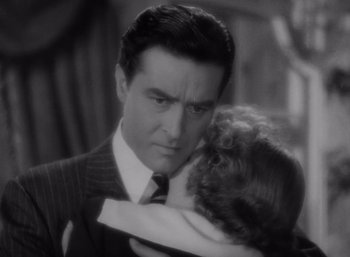 Movie still from “Arise, My Love” (1940), directed by Mitchell Leisen – A black and white photo of a man holding a child; Close Up shot, Over the shoulder angle